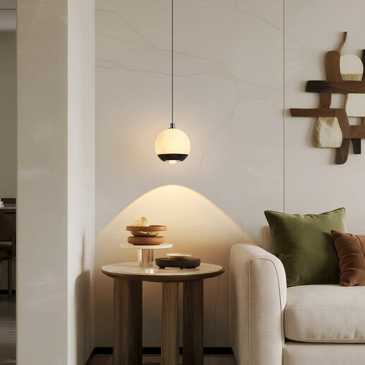 Modern delicate round pendant light featuring a natural marble finish and a lens light source at the bottom-1010