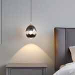 Modern creative eggshell crack-shaped pendant light featuring a lens light source at the bottom-945 - Image 2