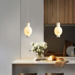 Modern-style oval pendant light with a faux marble finish, featuring an elegant design and a lens light source at the bottom that provides soft, ambient illumination.-986 - Image 3