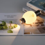 Modern-style oval pendant light with a faux marble finish, featuring an elegant design and a lens light source at the bottom that provides soft, ambient illumination.-986 - Image 5
